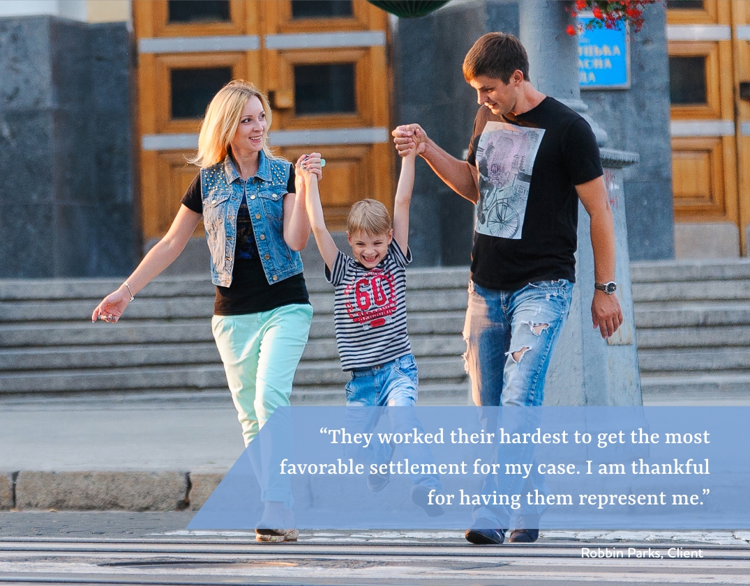 Happy young couple playing with child.