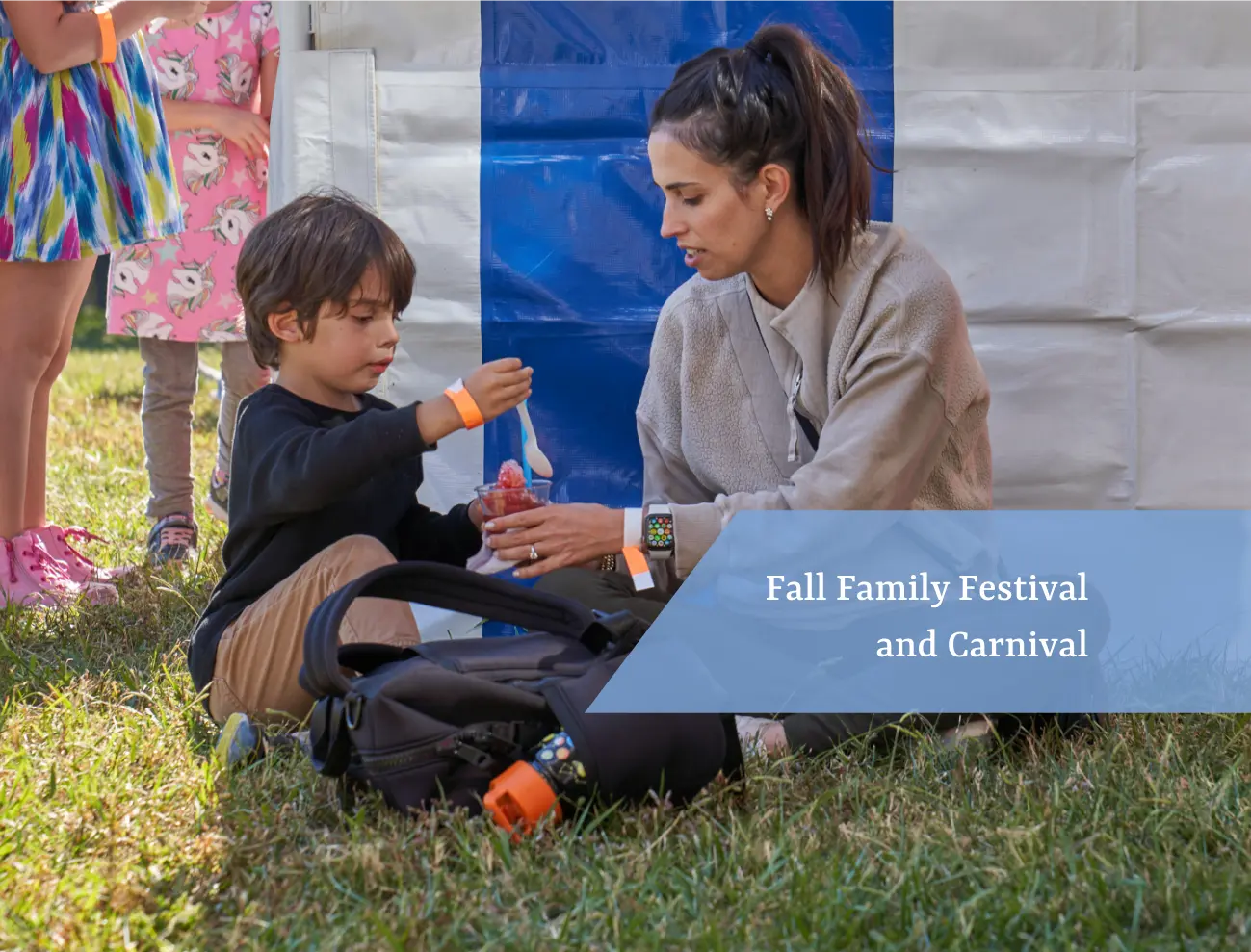 Woman and child having fun at Fall Family Festival and Carnival