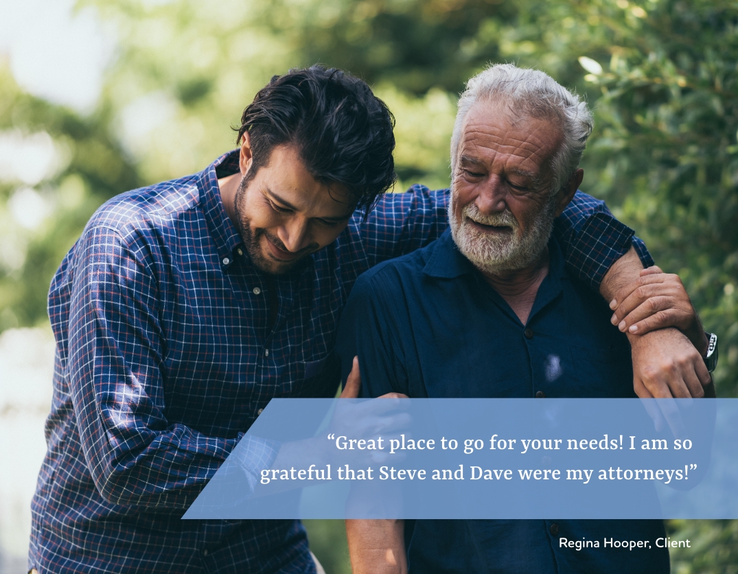 Younger man and elderly man smiling.