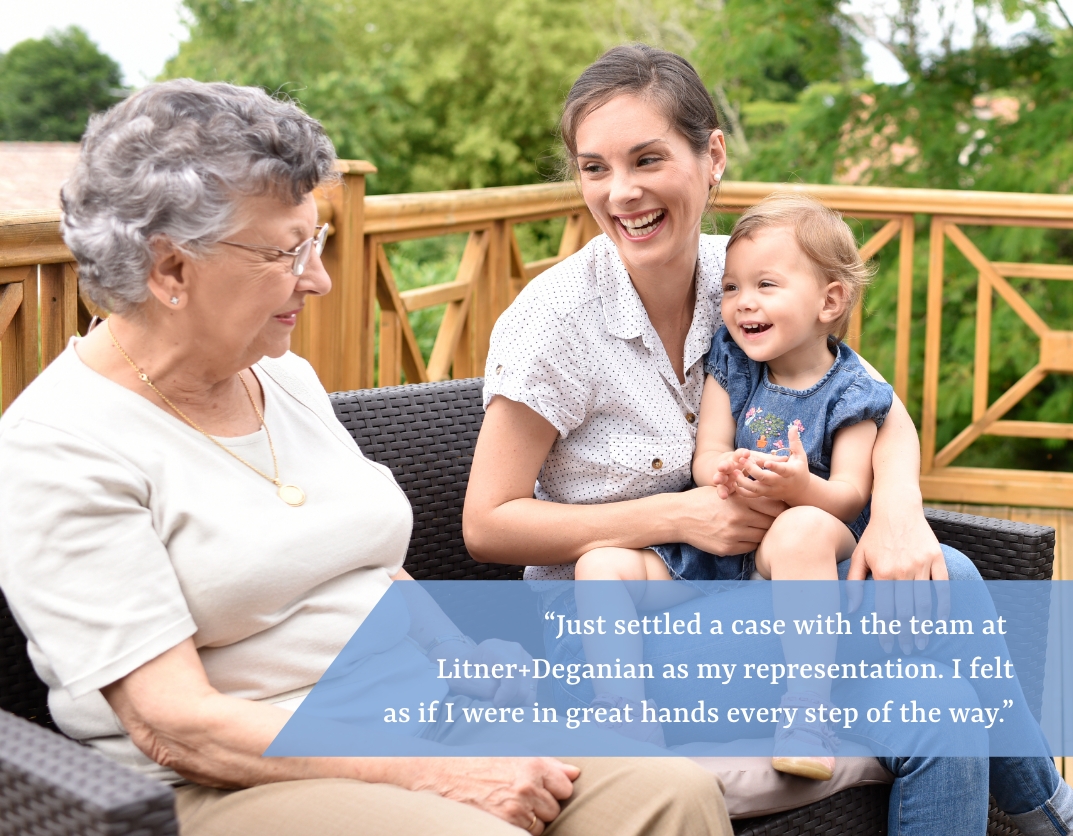 Young woman and baby laughing with an elderly woman.