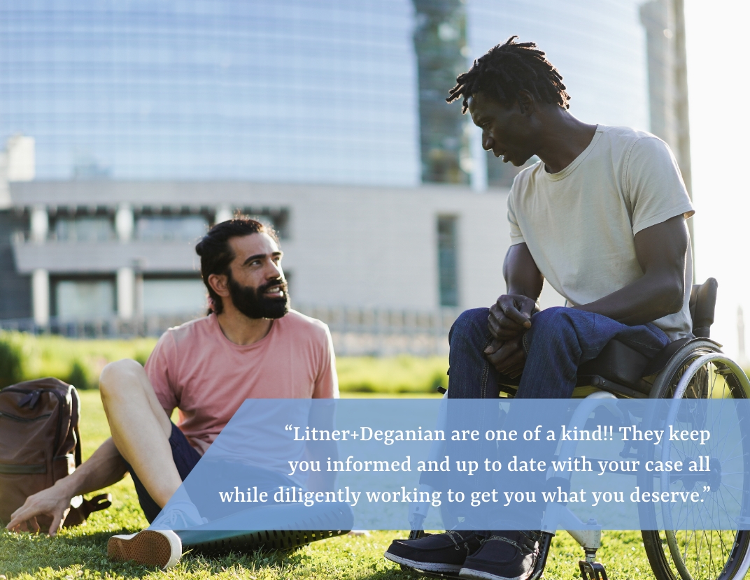 Two disabled men having a conversation in the grass.