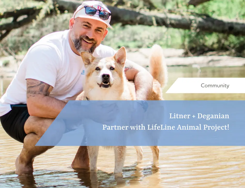 Posing with dog in river.